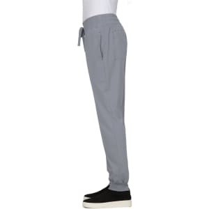 A pair of grey jogger pants with an elastic waistband and side pockets, featuring a logo on the garment.
