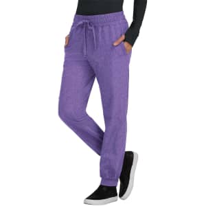 A pair of purple jogger pants with pockets, featuring an elastic waistband and cuffs, alongside a black top and shoes.
