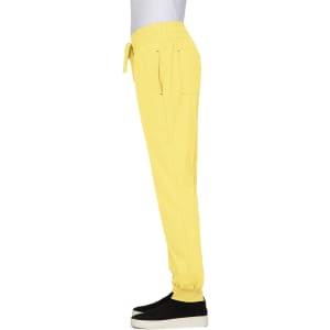 A pair of yellow jogger pants with an elastic waist and side pockets, featuring a logo on the back.