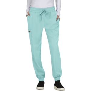 A pair of light turquoise jogger pants with pockets, featuring an elastic waistband and cuffs. There is a logo on the design.