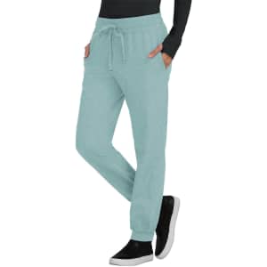 A pair of mint green jogger pants with a drawstring waist and side pockets, featuring a logo.