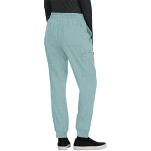 A pair of light blue jogger pants with an elastic waistband and pockets, worn with black sneakers.
