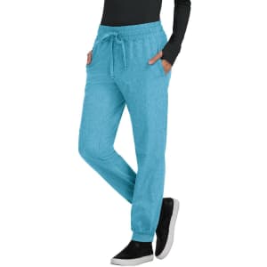 A pair of aqua jogger pants with a drawstring waist and side pockets, modelled with a black top and sneakers.