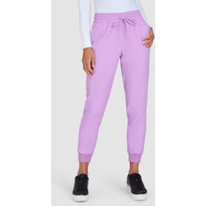 A pair of lilac jogger pants with an elastic waistband and cuffs, styled with a fitted white top.