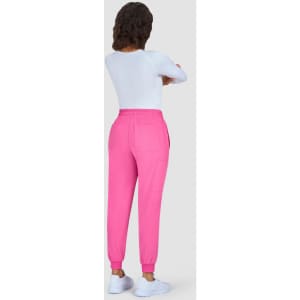 A pair of bright pink jogger pants with an elastic waistband, shown from the back on a model wearing a white top.