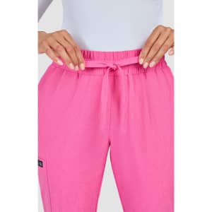 A close-up of pink jogger pants featuring a drawstring waist and a logo on the side.
