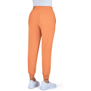 An orange jogger pant with a fitted cuff and an elastic waistband, featuring side pockets and a logo.