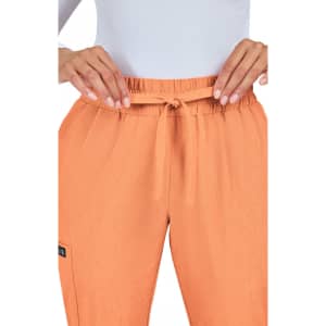 An orange jogger pant with a drawstring waist, featuring a small logo on the side.