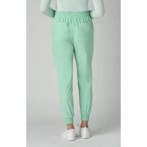 A pair of mint green jogger pants with an elastic waistband, featuring a tapered fit and side pockets.