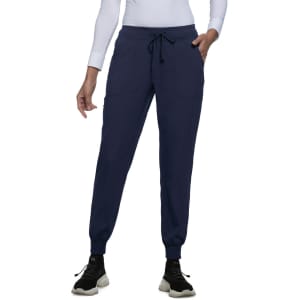 A pair of navy joggers with a drawstring waist and front pockets. Includes a logo on the waistband.