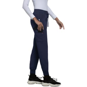 A pair of navy jogger pants featuring a zip pocket and an elastic waistband, complemented by stylish black sneakers.