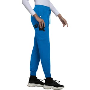 A pair of blue jogger pants with a side pocket and elastic cuffs, worn with black sneakers. Features a logo on the pocket.