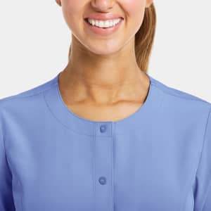 A round neck snap jacket in light blue with a button closure at the neck, featuring a logo on the fabric.