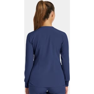 A women's round neck snap jacket in navy, featuring long sleeves and a fitted style. Includes a logo on the back.