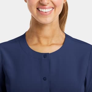 A women's round neck snap jacket in navy blue featuring a simple button closure and a close-up view of the neckline.