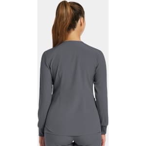 A women's round neck snap jacket in grey, featuring long sleeves and a plain design with a logo.