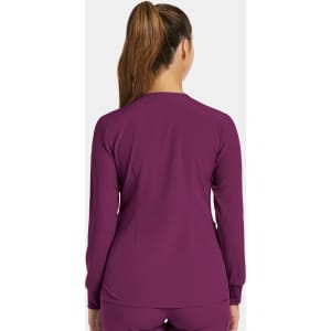 A women’s round neck snap jacket in a rich purple colour, featuring a simple design and long sleeves.