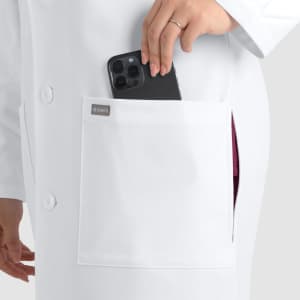 A white, unisex full-length lab coat with a pocket, holding a smartphone. Features a branding logo.