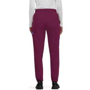 A pair of women's joggers in a deep plum colour, featuring a logo on the back and an elastic waistband.