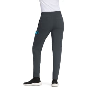 Comfortable grey jogger pants featuring a logo, with pockets and a fitted design, worn with black shoes.
