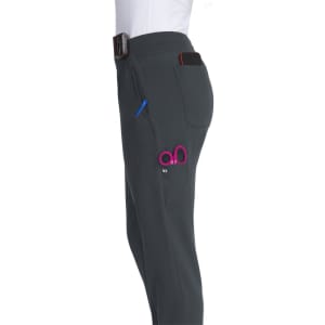 A pair of grey jogger pants featuring a side pocket and a pink logo, shown from the side.