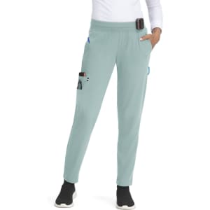 A pair of light green jogger pants with pockets, featuring a waistband and a logo on the side.