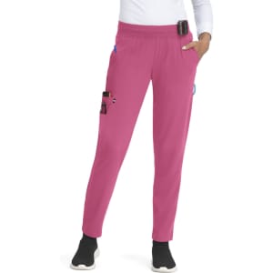 A pair of pink jogger pants with pockets, featuring a waistband and a small attached device, worn by a model.