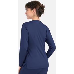 A woman in a navy round neck snap jacket, viewed from the back, showcasing its simple design.