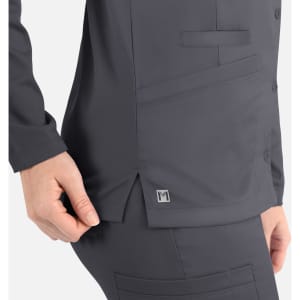 A dark grey women's jacket with a round neck and snap buttons, featuring a side pocket and a small logo.
