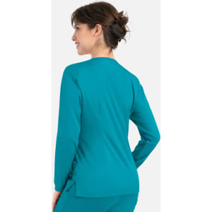 A women's round neck snap jacket in a vibrant teal colour, featuring a fitted design and long sleeves.