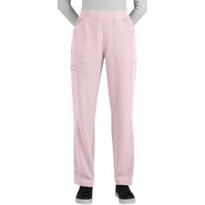Boot cut pants in a soft pink colour with side pockets, featuring an elastic waistband and a logo on the front.