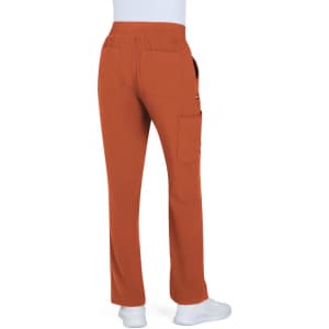 A pair of boot cut pants in a warm orange colour, featuring pockets and a comfortable waistband.
