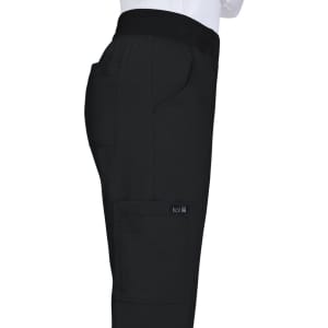 A pair of black pants featuring a side pocket, elastic waistband, and branding on the leg.