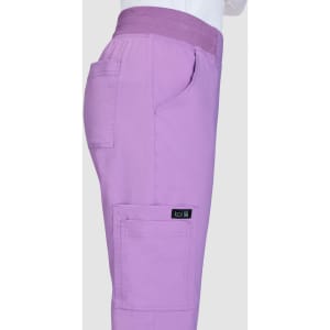 A pair of lilac pants featuring pockets and an elastic waistband, with a branding label on the side.
