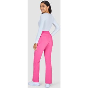 A pair of pink pants displayed on a model, featuring a back view and a white top. The image includes a logo.