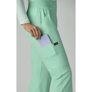 A mint green pant with a pocket, holding a phone, featuring a small logo on the side.