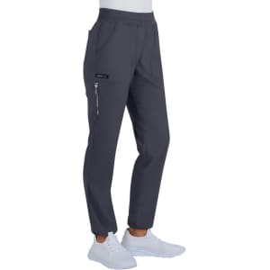 A pair of grey pants with pockets, featuring a logo, worn with white shoes.