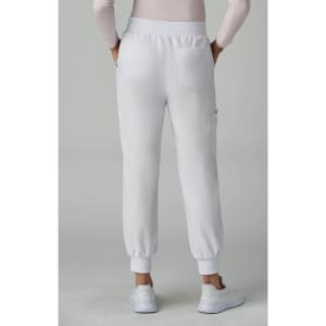 A pair of white jogger pants with elastic cuffs, featuring a back pocket. The model is facing away from the camera.