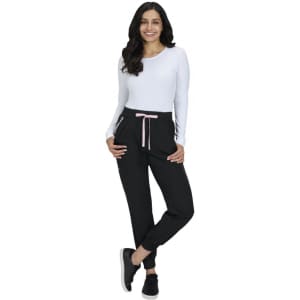 A pair of black jogger pants with a pink drawstring, displayed on a model wearing a white long-sleeve top.