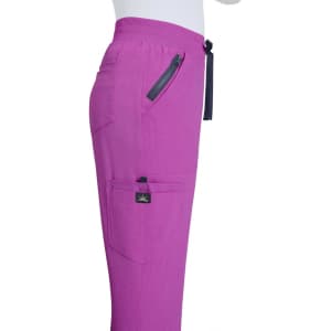 A pair of pink jogger pants with a side zipper pocket and a branding label on the waistband.