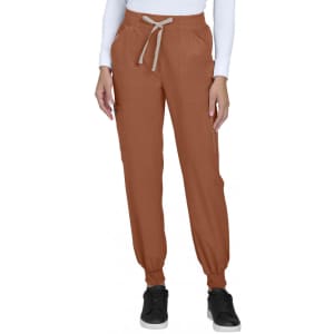 A pair of rust coloured joggers with side pockets, elastic cuffs, and a drawstring waistband, featuring a logo.