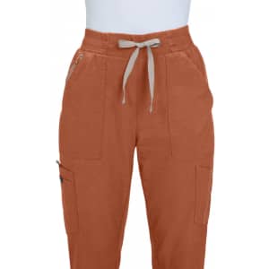 An orange pair of jogger pants featuring two front pockets and a drawstring waistband. It has a branding logo on one pocket.