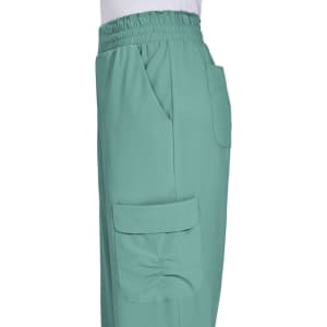 Ayla Pant in a soft green colour features an elastic waistband and side pockets. The product has a branding logo.