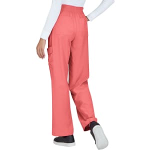 Coral-coloured pants with elastic waistband and pockets, viewed from the back with model wearing a white top.