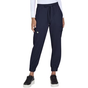 A pair of navy jogger pants with elastic cuffs and side pockets, worn with black sneakers. The pants feature a small logo.