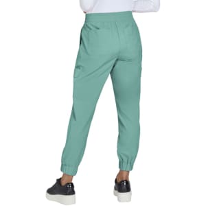 A pair of mint green jogger pants with elasticated cuffs, featuring side pockets and a relaxed fit.