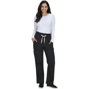 A woman wearing black wide-leg pants with a pink drawstring, paired with a long-sleeve white top and smiling.