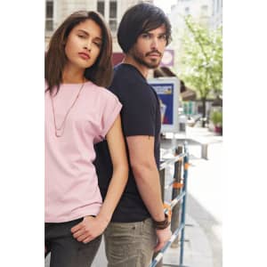 A pink ladies' casual T-shirt is worn by a woman, alongside a man in a navy T-shirt. Both are outdoors.