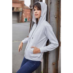 A grey ladies hoodie with a zip and pockets, worn by a model against a metal structure.