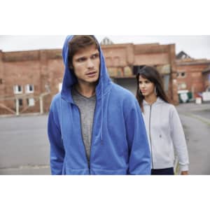 A blue zip hoodie and a grey zip hoodie worn by a man and a woman in an outdoor urban setting. Both hoodies have logos.
